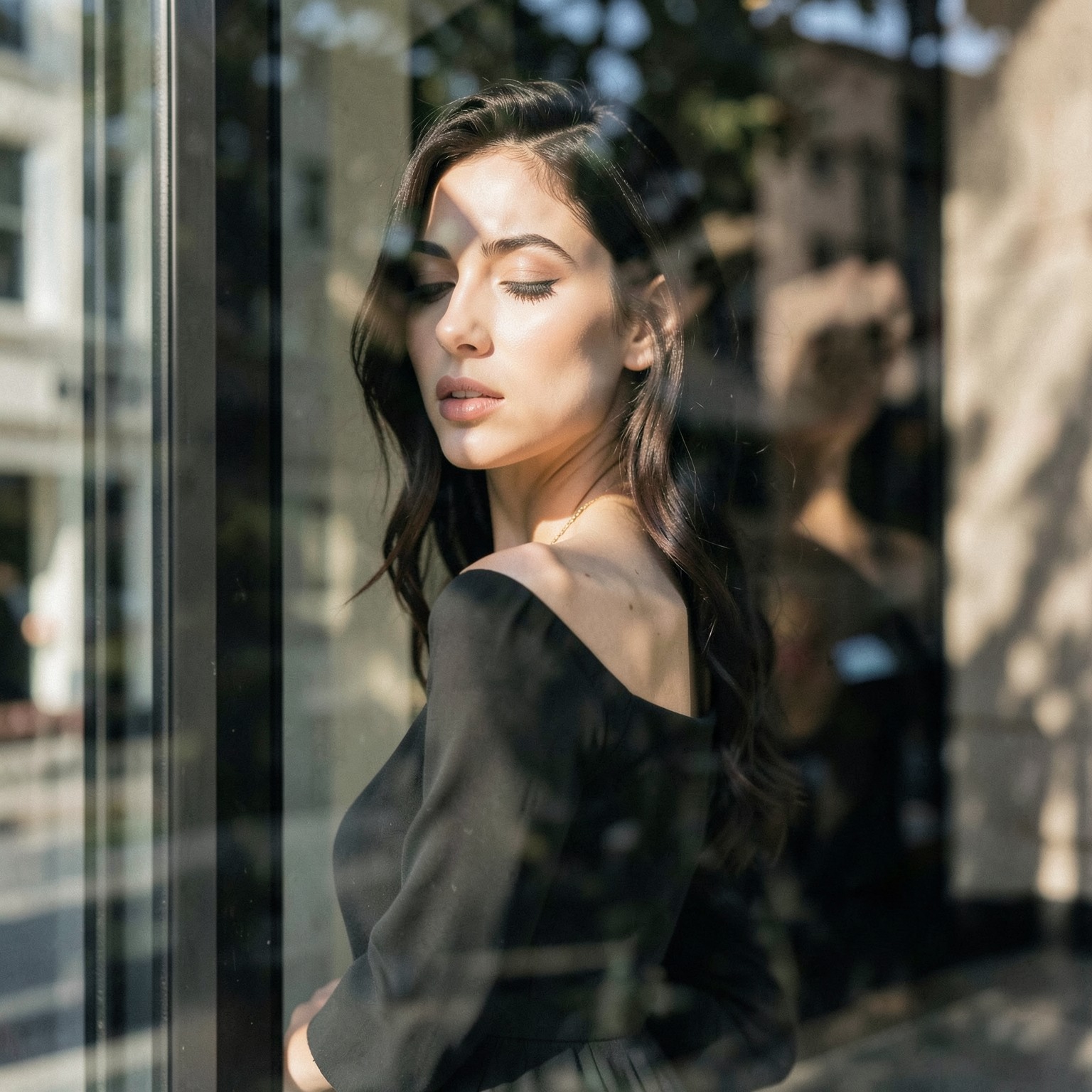 Elegant woman photographed through glass reflections, artistic fashion photography