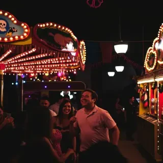 A colorful carnival scene filled with rides, games, and laughter, with bright lights and festive decorations, creating a joyful and energetic atmosphere.
